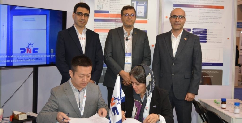 CEO and member of the board Ms. Bahareh Kaviani and Commercial manager Mr. Hamzeh Ghojavand are signing a contract between PNF Compmany and a chines company about nanomatarial in China